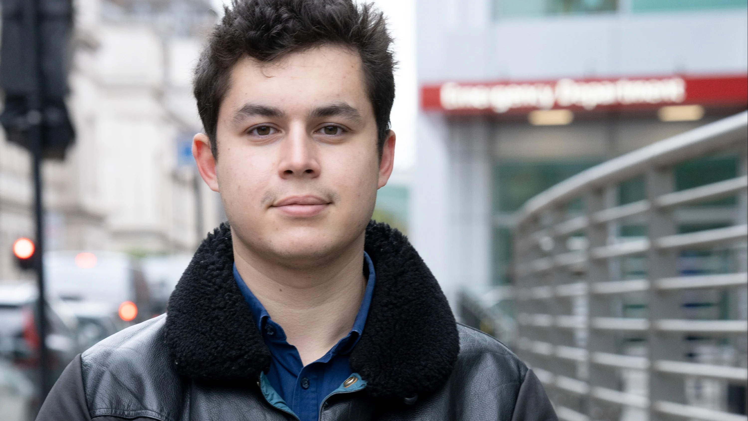 A photograph of Caspar standing in the street, with his hands clasped in front of him.