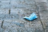 Blue face mask on the ground
