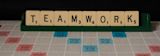 Decorative image of Scrabble tiles spelling 'Teamwork' for article
