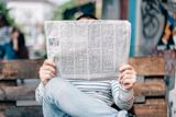 Decorative image of a person reading a newspaper for an article