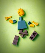 Broken Lego Person Green Background