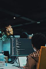Person working at a desk with a computer monitor