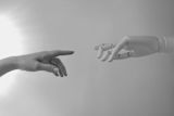 Decorative image of human hand and robot hand