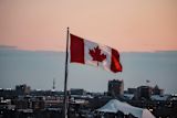 Flag of Canada over City