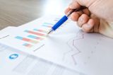 Decorative image of person looking at graphs for article