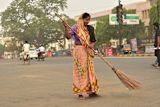 woman holding a broom stick