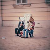Decorative image of two accordion players wearing horse heads for article
