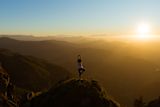 Decorative image of person doing yoga on a mountain for article