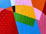Decorative image of colourful geometric patterns painted on a brick wall for article