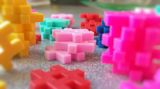 Decorative image of colourful interlocking and stacked plastic toys for article