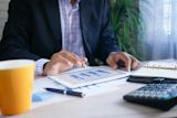 Decorative image of person looking at graphs for article
