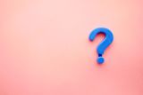 Question mark on pink wall