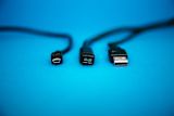 three black cables on a blue background