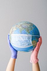Decorative image of globe wearing a mask for article