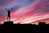 Decorative image of a silhouette of a man standing under a sunset for article