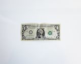 A single US dollar bill on a white background