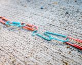 Decorative image of broken paper clip chain for article