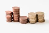 Decorative image of coins in piles for article