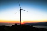 Decorative image of a wind turbine silhouette at twilight