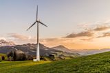 Decorative image of a wind turbine with mountains in the background