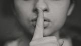 Decorative image of a woman with her finger over her mouth