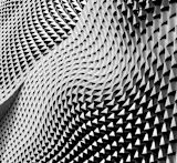 Decorative image of undulating and folding surface covered in three dimensional triangles for article
