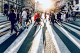 Decorative image of crowd of people crossing the road for article