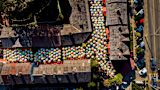 Aerial image of multicoloured umbrellas flooding the streets of a neighbourhood