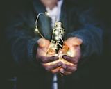 Decorative image of hands holding lightbulb for article