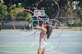 Decorative image of girl with multiple hula hoops for article