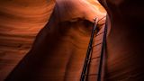 Decorative image of a ladder inside a cave