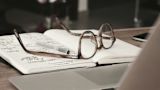 Decorative image of a notebook and spectacles for an article