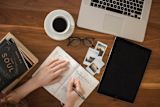 books, notes, coffee and a laptop on a desk