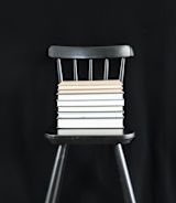 Books stacked on chair