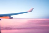 Decorative image of plane wing out of window for article