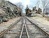 Image of two train tracks merging for article