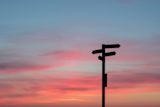 Decorative image of a road sign at sunset for article