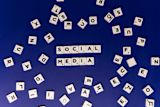 Decorative image of scrabble pieces that say social media