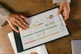 Decorative image of people pointing at graphs for an article
