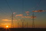 High-voltage electricity steel truss towers with power lines.