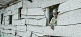 Boy in Rwanda looks out of window