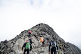 Decorative image of climbers reaching mountain peak for article