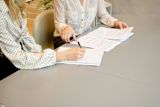 Decorative image of two people sitting at desk