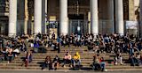 Decorative image of people sitting on the steps of Brussels Stock Exchange building for article