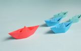 Decorative image of paper boats for article