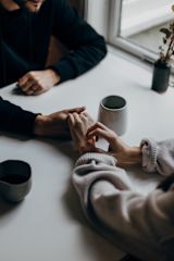 Decorative image of hands holding each other next to cups of tea for article