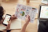 Decorative image of two people analysing graphs for Using the SDGs for Government Action lesson 2.1