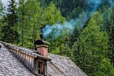 Decorative image of chimney on top of house for article