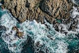 Waves crashing on a shore from a bird's eye view