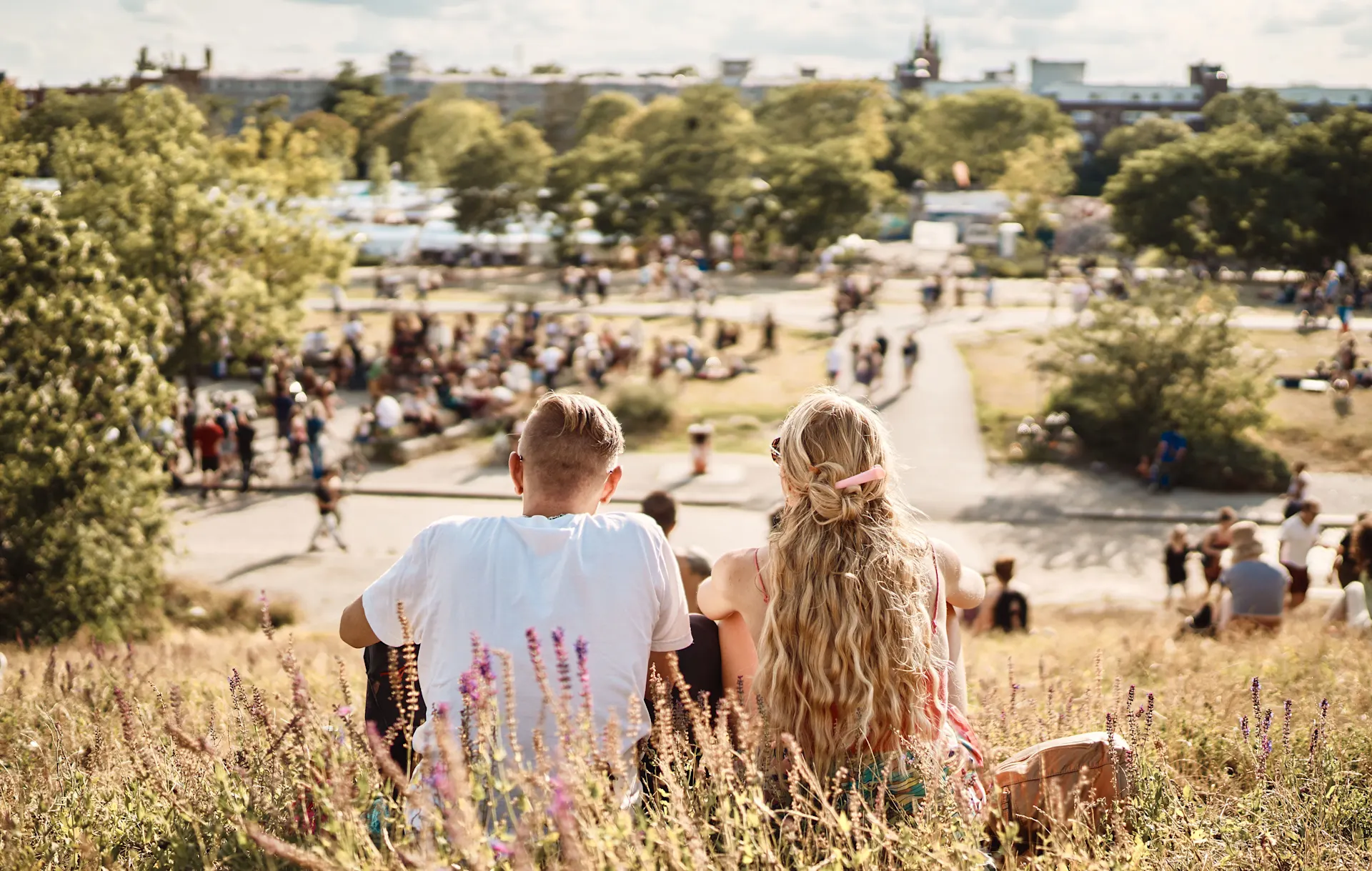Entspannen im Berlin Mauerpark Viele Menschen sitzen im Sommer gemütlich zusammen im Berliner Mauerpark auf einer Wiese.